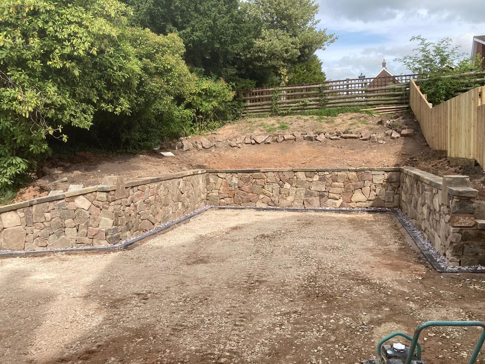 Hand-built stone retaining wall ready for resurfacing